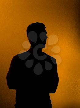 Confidence. Back lit silhouette of man in the darkness