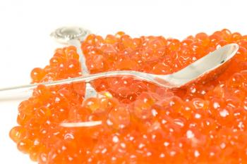 Expensive Red caviar and silver spoons. Delicatessen on white