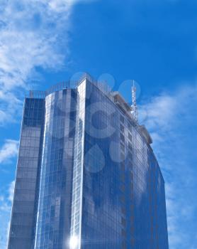 Glass and steel - Beautiful Futuristic skyscraper with blue sky reflection