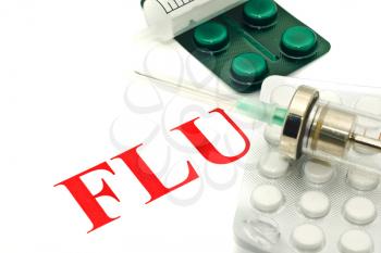 Swine FLU H1N1 warning - pills and syringe over white
