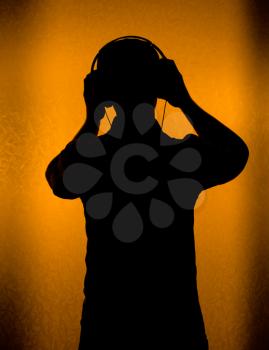 Music - silhouette of DJ with headset (back light)