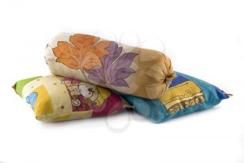 Pile of three colorful pillows over white background