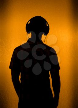 Listen to the Music - silhouette of man with headset (back light)