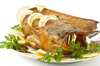 Tasty dinner - fresh-water catfish (sheatfish) with lemon and parsley