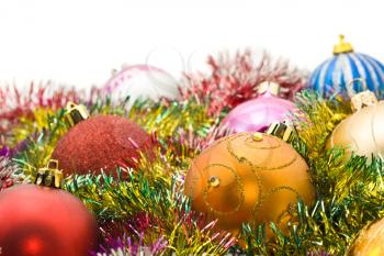 Xmas greetings - colorful decoration balls and tinsel and over white