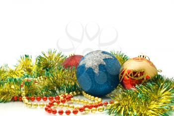Christmas Decoration - colorful tinsel and balls over white background