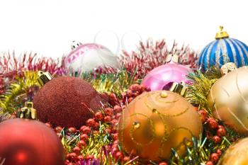 Group of Beautiful Christmas decoration balls and tinsel over white. Focused on one ball