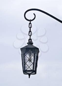 Old lantern in the street on the light background