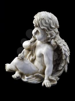 Small angel with a dove over black background