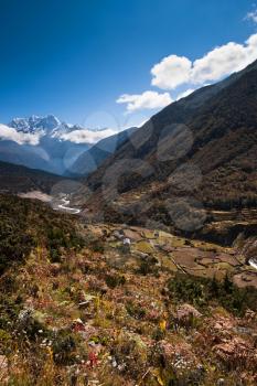 Himalaya landscape: snowed peaks and highland village. Pictured in Nepal