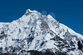Snowbound mountain peaks in Himalayas. Alpinism and hiking