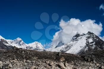 Peaks and clouds near Sacred Lake of Gokyo in Himalayas. Travel to Nepal