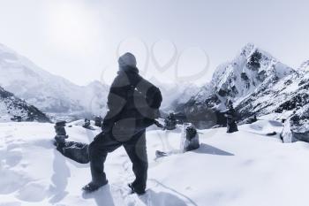 Mountain climbing: Alpinist on the peak in the Himalaya during sunrise. Cho La Pass