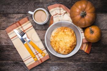 Pumpkins, coffee and flat cake on wooden table. Breakfast and lunch Food photo