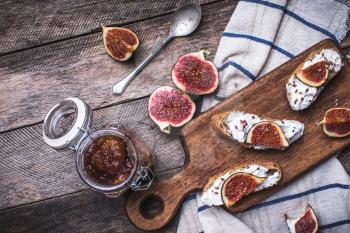 Tasty Bruschetta snacks with figs on napkin in rustic style. Breakfast, lunch food photo