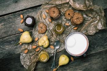 Tasty Pears almonds Cookies and milk on rustic wood. Rustic style and autumn food photo