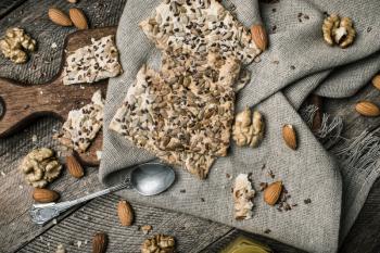 Tasty Cookies with seeds nuts honey on wood for diet. Rustic style and autumn food photo