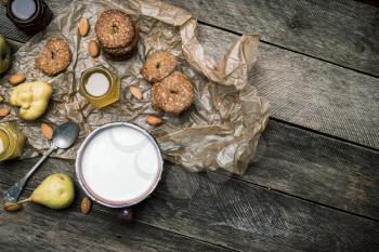 Tasty Pears almonds Cookies and joghurt on rustic wood. Rustic style and autumn food photo