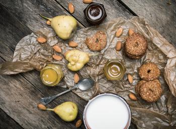 Tasty Pears almonds Cookies and milk on rustic wood. Rustic style and autumn food photo