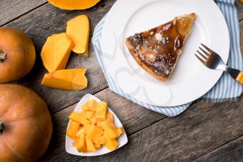 Pumpkin slices and piece of pie in Rustic style. Food photo