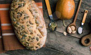 pumpkin with bread and seeds on Rustic wood. Autumn Season food photo