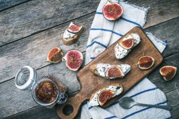 rustic style snacks with jam cheese and figs on wood board in rustic style. Breakfast, lunch food photo