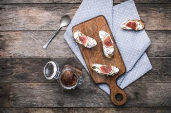 rustic style tasty Bruschetta snacks with jam and figs on napkin. Breakfast, lunch food photo