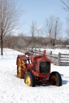 Royalty Free Photo of a Vintage Tractor in Snow