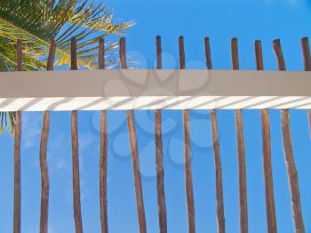 Tropical resort fence agains the blue caribbean sky