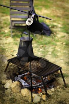 Ancient tea kettle on campfire.