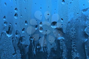 window glass with water drops and frost