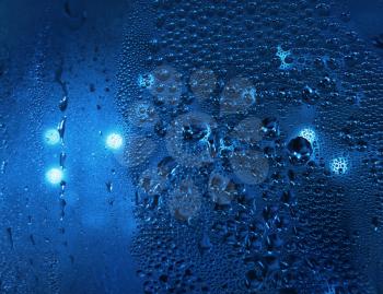 water drops and light at night window