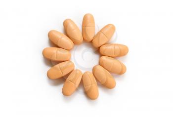 orange pills in the form of a flower isolated on white background