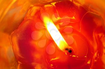 red burning candle close-up background