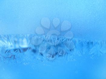 blue frosty natural pattern on winter window