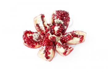 Close-up of tasty cut pomegranate fruit on white background