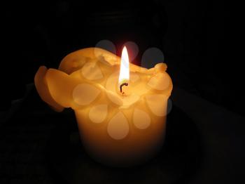 Brigt candle burning in the dark                        