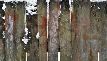 Closeup of old wooden fence in winter
