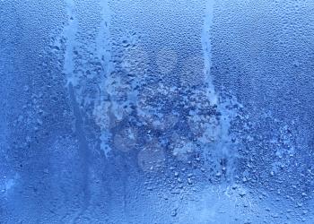 Nature background with frozen water drops on window glass 