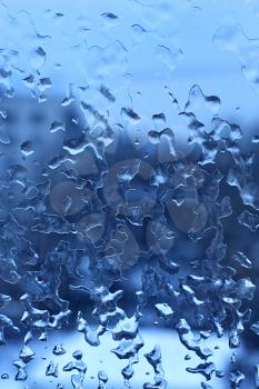 Natural blue texture with frozen water drops on the glass