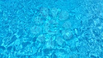 Texture of blue ripped water in swimming pool