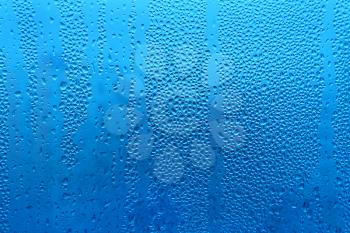 Water drops on glass naural blue texture