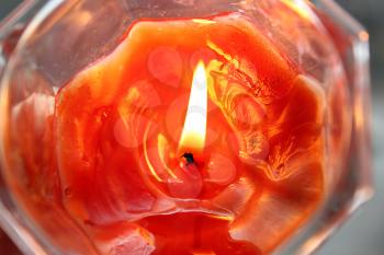 Closeup of orange burning candle