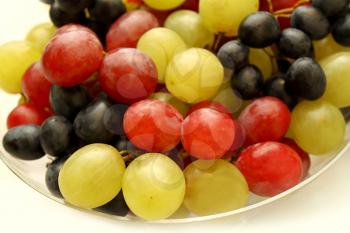 Closeup of bright tasty ripe grapes in a glass plate