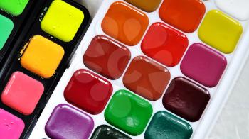 Bright colorful watercolor paints closeup