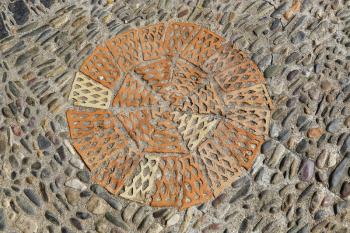Patterned floor with sea pebbles and red bricks in the park Montjuic, Barcelona, Catalonia, Spain