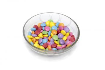 Bright colorful candy in bowl isolated on white background