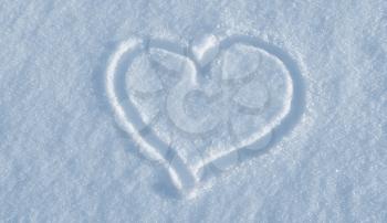 The shape of heart drawing on the white snow 
