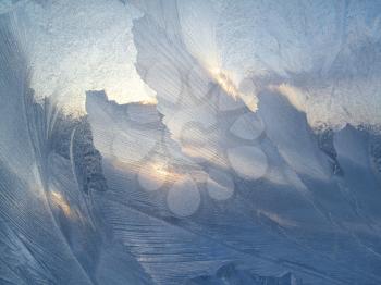 Beautiful ice pattern and sunlight on winter glass