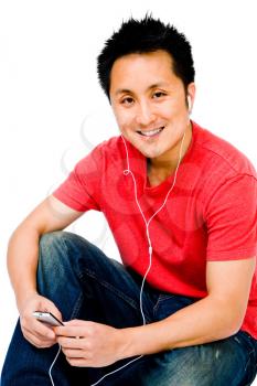 Royalty Free Photo of a Man Sitting Down Listening to an Mp3 Player